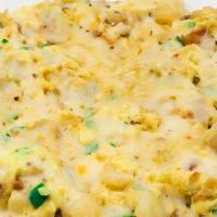 Huevos Con Papas · Scrambled eggs, sauteed anaheim peppers, potatoes, onion, pepper Jack cheese, and salsa. Ser...