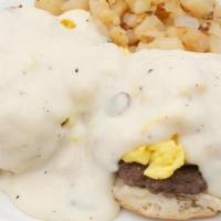 Country Benedict · Biscuit and open-faced, topped with two sausage patties and two scrambled eggs with creamy s...