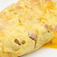 Ham And Cheddar Omelette · With signature French rolled, oven-baked, four egg omelette, and choice of side.