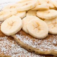 Fresh Banana Pancake · With tropical syrup, freshly whipped cream, and powdered sugar.