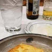 Saganaki · The famous sauté cheese Greek appetizer. It's made with blend of cheeses, sliced tomatoes, p...