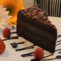 Triple Chocolate Cake · Delicious, moist, and rich chocolate cake with shaved chocolate on top.