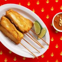 Spicy Chicken Satay · Grilled satay chicken skewers with a peanut dipping sauce.