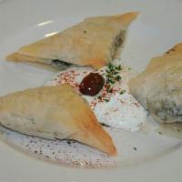 Spanakopita · Mixture of spinach, feta cheese and spices wrapped in delicate phyllo dough baked until gold...