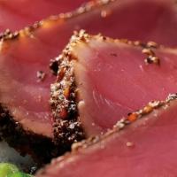 Seared Pepper Ahi · Seared rare with garlic pepper seasoning. Served with a creamy ginger soy sauce and wasabi.