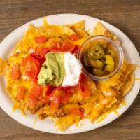 Nachos Supreme · Loaded corn chips with beans, ground beef, cheese, tomatoes, sour cream, guacamole and jalap...