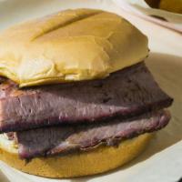 Brisket Sandwich · Slow smoked and brisket. Served with barbecue sauce on a toasted bun.