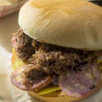 The Deadbeat · Chopped brisket, jalapeno sausage, mustard, pickles, onions, and barbecue sauce on a toasted...