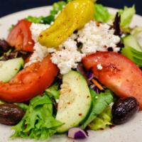 Greek Salad · Romaine lettuce, spring mix, tomato, cucumber, olives reed cabbage, carrots & feta cheese.