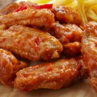 Sweet Chili Chicken Wings · Mouthwatering Chicken wings, tossed in a Sweet Chili sauce and fried to perfection. Served i...