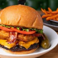 Carnegie Hall Burger · Topped with bacon, nosh sauce, cheddar cheese, jalapeño cream cheese bites, lettuce, and tom...