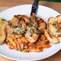 Rustic Shrimp · Pesto marinated shrimp on penne pasta tossed with rustic tomato sauce, sautéed mushrooms, co...