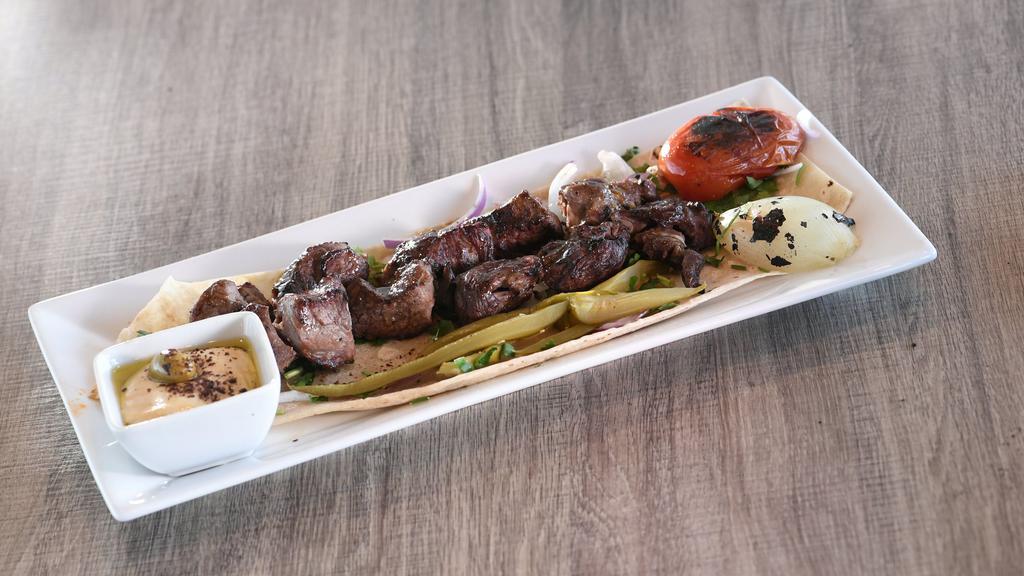 Lamb Tikka · Two skewers of marinated lamb medallions
Served with one flatbread