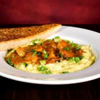 Shrimp & Grits · Green chili cheddar cheese grits topped with sautéed shrimp, bacon, mushrooms & green onions...