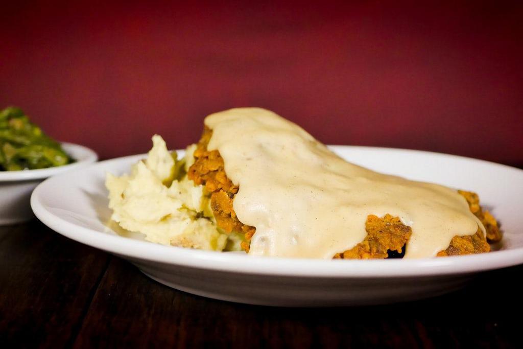 Country Fried Steak · Fresh hand-cut Black Angus sirloin tenderized, hand-breaded and fried. Topped with our lodge inspired scratch made cream gravy. Served with mashed potatoes & your choice of one scratch made side.