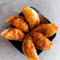 Mandoo Dumplings · Fried beef and pork dumplings drizzled with our signature Sweet Glaze