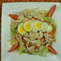 Grilled Thai Chicken Salad · Grilled chicken served over lettuce, vegetables and fresh herbs in a Thai lime or peanut dre...
