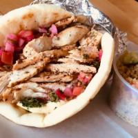 Shawarma Chicken Roll · Grilled chicken breast wrapped in pita with hummus and mixed pickles and tahini garlic sauce.