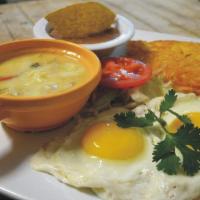 Huevos Rancheros · Two eggs over corn tortillas topped with chile con queso served with hash browns and beans.