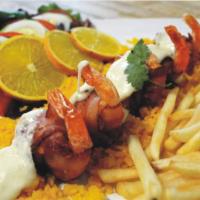 Camarones Fiesta · Jumbo shrimp wrapped with bacon and stuffed with ham cheese, served with French fries or bak...