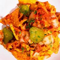 Kimcheese Nachos · Seasoned tortilla chips topped with oozy nacho cheese, gochujang aioli, kimchi salsa, choppe...