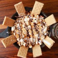 S'Mores Skillet · Chocolate chip cookie topped with chocolate and marshmallow sauce, whipped cream and crushed...
