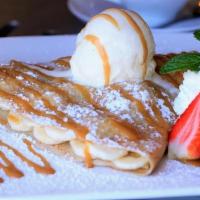 Bananas Foster · Sliced bananas and caramel sauce topped with powdered sugar, more caramel sauce a scoop of o...