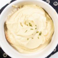 Hummus · Puree chickpea-sesame dip blended with olive oil, lemon juice and garlic served with pita br...