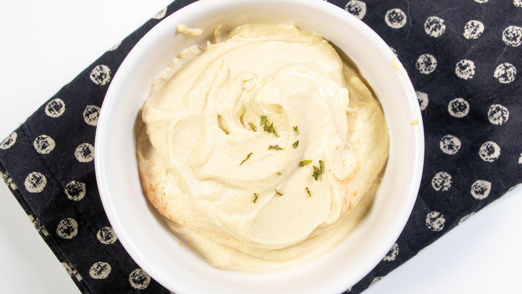Hummus · Puree chickpea-sesame dip blended with olive oil, lemon juice and garlic served with pita bread.