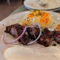 Lamb Tikka Kabab · A skewer of marinated lamb, cooked over an open flame, served with grilled tomato, garlic sa...