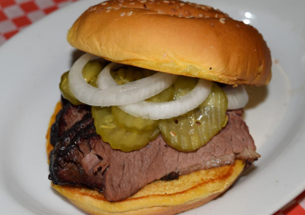 Sliced Beef · 1/3 of a pound of our slow hickory smoked brisket on a whole egg bun, sauce on the side. Pickles and onions upon request. EXCELLENT!