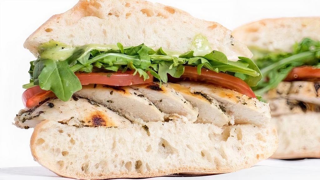 Basil Chicken · Herb-marinated roasted chicken, tomato, red onion, provolone, arugula, basil aioli on ciabatta Served with a side of house-seasoned kettle chips..