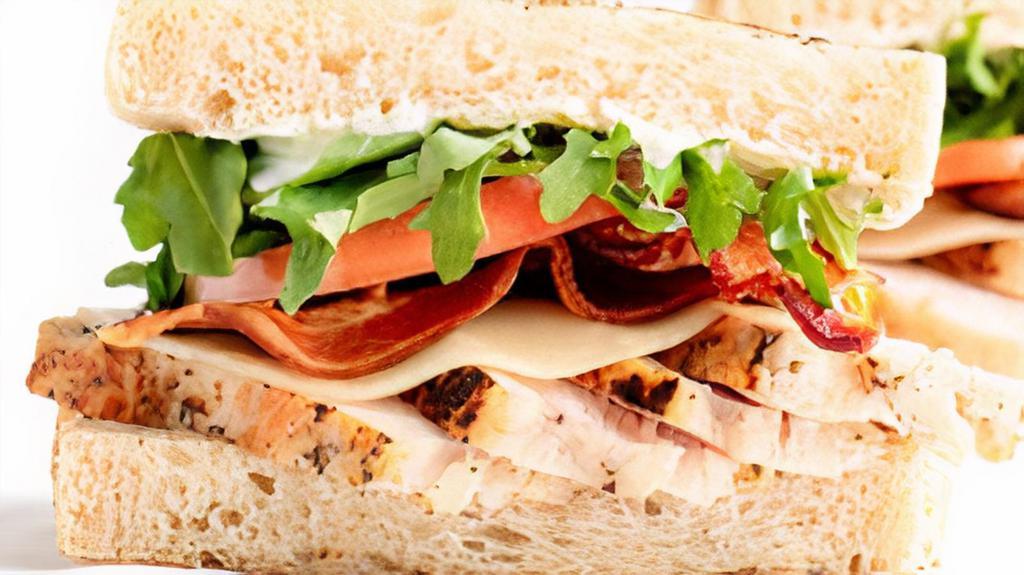 Chicken Bacon Club · Herb-marinated roasted chicken, nitrate-free bacon, provolone, tomato, arugula, scallion ranch on sourdough. Served with a side of house-seasoned kettle chips..