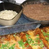 Enchiladas Al Carbon · 2 flour tortillas filled with fajita topped with gravy chile and cheese. Served with rice an...