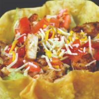 Taco Salad · Crispy tortilla bowl filled with lettuce, tomato, cheese, beans and topped with ground beef ...