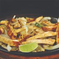 Chicken Dinner · Tender fajitas sizzling hot with grilled onions and bell peppers served with refried beans, ...