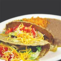 Tacos Plates · Three tacos on a large plate served with rice and refried beans.