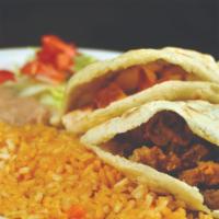 Gorditas · Two gorditas (corn patties) filled with ground beef or chicken served with refried beans and...