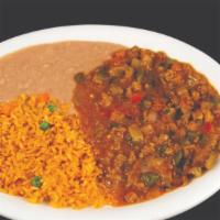 Bistec A La Mexicana · A stir-fry of steak strips, pepper, onions, tomatoes, and ranchero sauce served with refried...