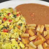 Huevos Rancheros · SUNNY SIDE EGGSSIDE UP ON CORN TORTILLA TOPPED WITH RANCHERO SAUCE SERVED WITH BEANS AND POT...