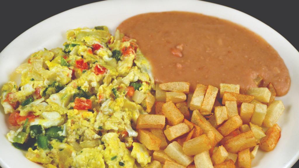Huevos Rancheros · SUNNY SIDE EGGSSIDE UP ON CORN TORTILLA TOPPED WITH RANCHERO SAUCE SERVED WITH BEANS AND POTATOES