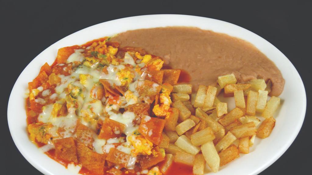 Migas · SCRAMBLED EGGS MIXED WITH WITH CORN TORTILLA CHIPS AND TOPPED WITH MOZZARELLA CHEESE SERVED WITH BEANS AND POTATOES