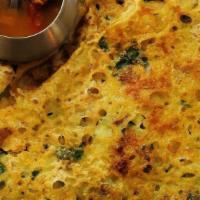 Ghee Rava Masala Dosa · Thin crispy crepe from semolina and rice sprinkled with ghee, mildly spiced, and garnished s...