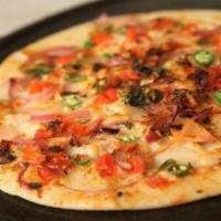 Onion & Chilli Uthappam · Thick rice and lentil pancake topped with onions and chilis.