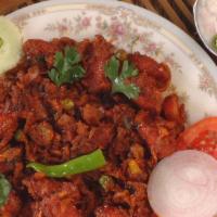 Kaima Idly · Deep fried mini idly sauteed in regional spices  served with raitha.