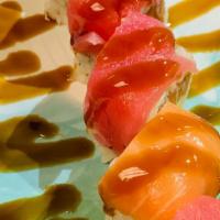 Tiger Roll · Salmon, avocado and cucumber inside topped with snow crab tuna, salmon and sauce.