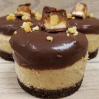 Snickers · Our peanut butter cheesecake with Snickers candy pieces inside, dipped in our chocolate gana...