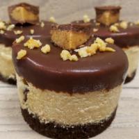 Peanut Butter Cup · Our peanut butter cheesecake with Peanut Butter Cup pieces inside, dipped in our chocolate g...