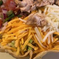 Taco Salad · With choice of ground beef or shredded chicken fajita inside tortilla shell filled with bean...