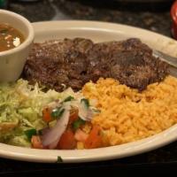 Carne Asada · 8 oz marinated steak tenderloin with charro beans, guacamole salad, and flour or corn tortil...
